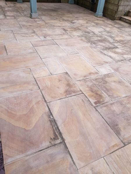 Indian sandstone cleaning in Heanor, This rainbow sandstone patio had been cleaned by the home owner but he could not remove the black staining, check out the next picture to see what a professional clean looks like!: Swipe To View More Images